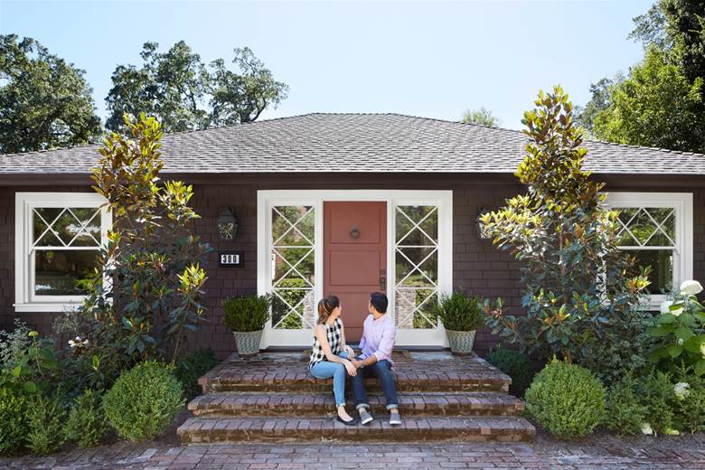 Couple sitting in front of house
