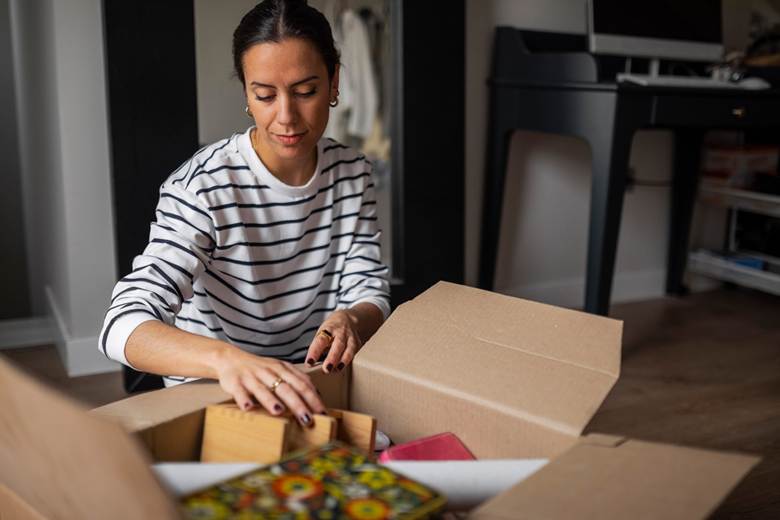 Woman packing things into box