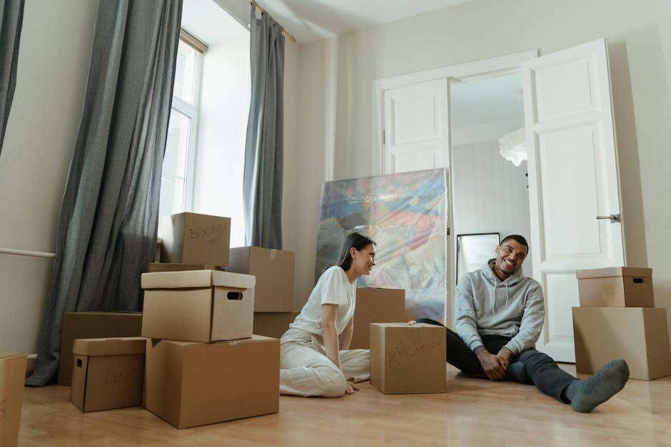 Moving boxes stacked near the front door of a rental apartment