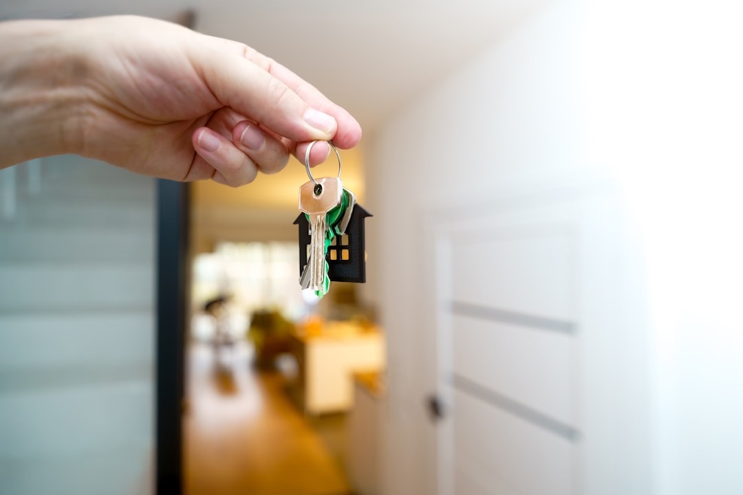 A person handing over house keys across a table